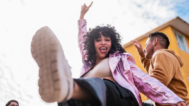 
		Junge Frau tanzt fröhlich
	